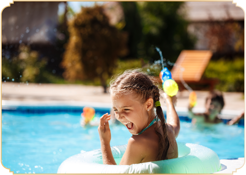Children enjoying a safe and vibrant swimming pool area at MM Valley